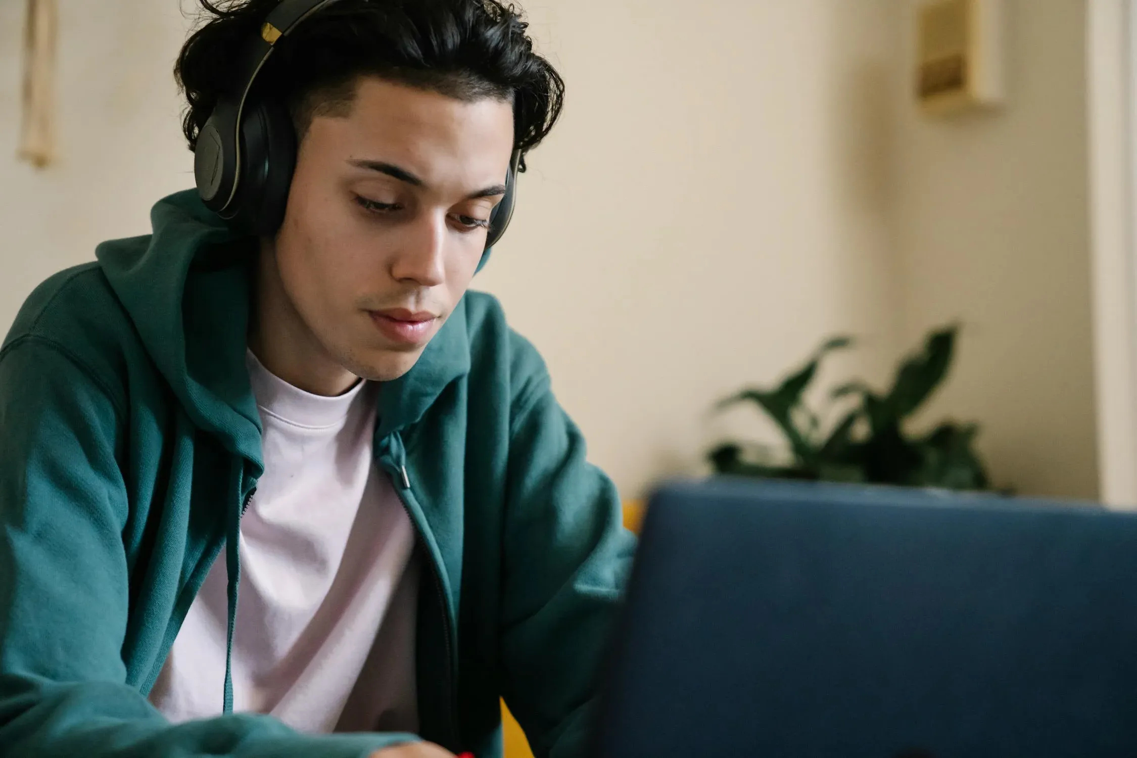 Student looking at computer in a room.